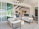Covered patio with comfy seating overlooking the pool and lake at 19405 Ganton Ave, Lakewood Ranch, FL 34202