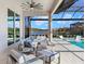 Relaxing pool area with covered lanai, lounge chairs, and lake view at 19405 Ganton Ave, Lakewood Ranch, FL 34202