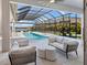 Luxury pool and patio with covered seating and stunning water views at 19405 Ganton Ave, Lakewood Ranch, FL 34202