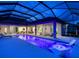 Night view of a relaxing pool and lanai with lake view at 19405 Ganton Ave, Lakewood Ranch, FL 34202