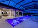 Night view of a luxurious pool and patio with a covered lanai at 19405 Ganton Ave, Lakewood Ranch, FL 34202