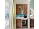 Wet bar with beverage cooler and wood cabinetry at 19405 Ganton Ave, Lakewood Ranch, FL 34202