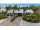 Aerial view of a charming house with a tropical landscape and a paved driveway at 213 83Rd St # West, Holmes Beach, FL 34217