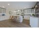 Modern kitchen boasts white shaker cabinets, quartz countertops, and a kitchen island at 213 83Rd St # West, Holmes Beach, FL 34217