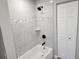 Bathroom with tub/shower combo and gray tile at 25484 Terrain Ln, Punta Gorda, FL 33983