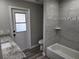Bathroom with tub/shower, gray tile, and granite vanity at 25484 Terrain Ln, Punta Gorda, FL 33983