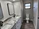 Bathroom with double vanity, granite countertop, and gray flooring at 25484 Terrain Ln, Punta Gorda, FL 33983