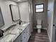 Bathroom with double vanity, granite countertop, and gray flooring at 25484 Terrain Ln, Punta Gorda, FL 33983