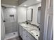 Updated bathroom with double vanity and walk-in shower at 25484 Terrain Ln, Punta Gorda, FL 33983