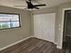 Bedroom with ceiling fan, double-door closet, and wood-look floors at 25484 Terrain Ln, Punta Gorda, FL 33983