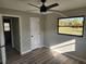 Bedroom with ceiling fan and view of backyard at 25484 Terrain Ln, Punta Gorda, FL 33983