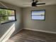 Bright bedroom with wood-look floors and ceiling fan at 25484 Terrain Ln, Punta Gorda, FL 33983