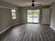 Bedroom with hardwood floors and sliding glass doors to pool at 25484 Terrain Ln, Punta Gorda, FL 33983