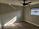 Bright bedroom with ceiling fan and wood-look flooring at 25484 Terrain Ln, Punta Gorda, FL 33983