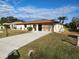Single-story house with a two-car garage and landscaped yard at 25484 Terrain Ln, Punta Gorda, FL 33983