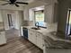 Modern kitchen with white cabinets, granite countertops, and a sink overlooking the pool at 25484 Terrain Ln, Punta Gorda, FL 33983