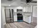 Modern kitchen featuring stainless steel appliances and granite countertops at 25484 Terrain Ln, Punta Gorda, FL 33983