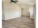Open living area with light walls, wood-look floors, and ceiling fan at 25484 Terrain Ln, Punta Gorda, FL 33983