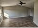 Spacious living room featuring light gray walls and wood-look flooring at 25484 Terrain Ln, Punta Gorda, FL 33983