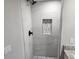 Updated shower with gray tile and niche at 25484 Terrain Ln, Punta Gorda, FL 33983