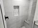 Modern shower with gray tile, built-in seat, and mosaic accent at 25484 Terrain Ln, Punta Gorda, FL 33983