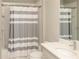 Bathroom with shower/tub and gray striped curtain at 4406 Rustling Pines Ter, Parrish, FL 34219