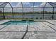 Screened-in pool with a tanning ledge and lake view at 4406 Rustling Pines Ter, Parrish, FL 34219