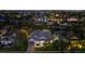 Night view of a waterfront home with beautifully lit landscaping at 4611 Shark Dr, Bradenton, FL 34208