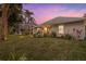 Landscaped backyard with lush grass and tropical plants at 4611 Shark Dr, Bradenton, FL 34208