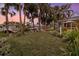 Waterfront backyard with lush grass and palm trees at 4611 Shark Dr, Bradenton, FL 34208