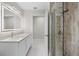 Updated bathroom with white cabinets, a large mirror, and a walk-in shower at 4611 Shark Dr, Bradenton, FL 34208