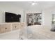 Serene bedroom with large TV and access to the pool area at 4611 Shark Dr, Bradenton, FL 34208