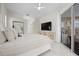 Bright bedroom with a large TV and sliding doors to the pool at 4611 Shark Dr, Bradenton, FL 34208