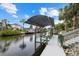 Private boat dock with covered lift and canal views at 4611 Shark Dr, Bradenton, FL 34208