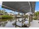 Covered boat lift with spacious dock and canal access at 4611 Shark Dr, Bradenton, FL 34208
