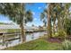 Serene canal view with hammock and lush landscaping at 4611 Shark Dr, Bradenton, FL 34208