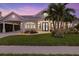 Well-maintained house featuring a welcoming front porch and lush landscaping at 4611 Shark Dr, Bradenton, FL 34208