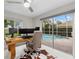 Bright home office with pool view, built-in desk, and comfortable seating at 4611 Shark Dr, Bradenton, FL 34208