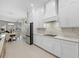 White kitchen with stainless steel appliances and marble backsplash at 4611 Shark Dr, Bradenton, FL 34208