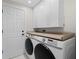 Laundry room with white cabinets, wood countertop, and Samsung washer/dryer at 4611 Shark Dr, Bradenton, FL 34208