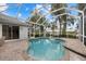 Inviting pool area with covered patio, spa, and brick pavers at 4611 Shark Dr, Bradenton, FL 34208