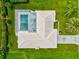 Overhead view of home's roof and private screened-in pool surrounded by lush landscaping at 482 Rubens Dr E, Nokomis, FL 34275