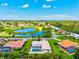 Picturesque aerial view featuring homes with pools, a serene lake, and lush green landscapes at 482 Rubens Dr E, Nokomis, FL 34275