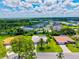 Aerial view of a neighborhood with beautiful homes and lakes surrounded by lush greenery at 482 Rubens Dr E, Nokomis, FL 34275
