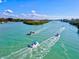 Scenic aerial view of boats cruising along the waterway on a bright, sunny day at 482 Rubens Dr E, Nokomis, FL 34275