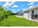 Lovely backyard featuring lush lawn, mature landscaping, and screened-in pool for outdoor enjoyment at 482 Rubens Dr E, Nokomis, FL 34275