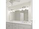 Bathroom featuring double vanity with modern lighting and large mirror at 482 Rubens Dr E, Nokomis, FL 34275