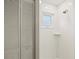 Modern all white shower stall with shower head, shelf and window at 482 Rubens Dr E, Nokomis, FL 34275