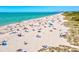 Scenic beach with crystal-clear blue water and numerous people enjoying the sun and sand at 482 Rubens Dr E, Nokomis, FL 34275