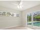 Bedroom featuring a ceiling fan and views to the pool area at 482 Rubens Dr E, Nokomis, FL 34275